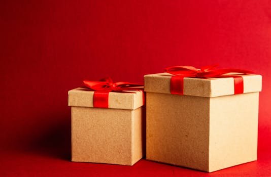 Two gift boxes with red ribbons on a vibrant red background.